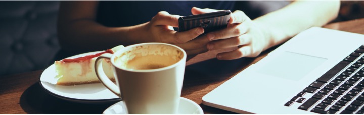 Woman at a coffee shop with her phone